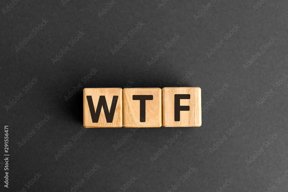Aufkleber wtf - word from wooden blocks with letters, wtf concept, top view on grey background