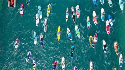 Aerial bird's eye view photo taken by drone of stand up paddle surfers in annual SUP crossing...