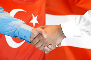 Business handshake on the background of two flags. Men handshake on the background of the Turkey and Austria flag. Support concept