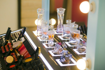 Obraz na płótnie Canvas variety cosmetics perfumes stand makeup test probes