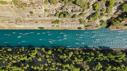 Aerial bird's eye view photo taken by drone of stand up paddle surfers in annual SUP crossing competition in Corinth Canal, Greece