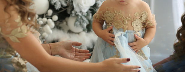 mom and baby at Christmas in beautiful outfits