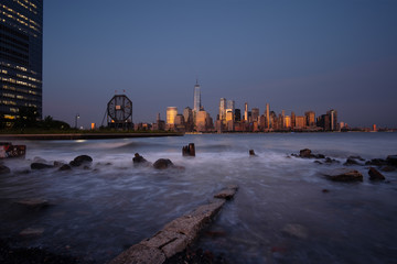 Lower Manhattan skyline with boat and ferry on Hudson river view from Liberty State Park in late summer