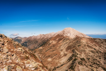Vihren and Kutelo peaks with the horse traverse in Pirin national park, Bulgaria. Panoramic  view from Muratov peak.