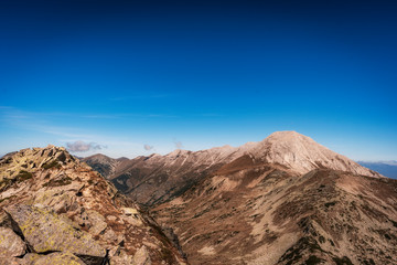 Fototapeta premium Vihren and Kutelo peaks with the horse traverse in Pirin national park, Bulgaria. Panoramic view from Muratov peak.