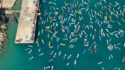 Aerial bird's eye view photo taken by drone of stand up paddle surfers in annual SUP crossing competition in Corinth Canal, Greece