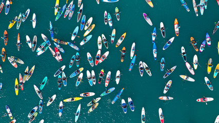 Aerial bird's eye view photo taken by drone of stand up paddle surfers in annual SUP crossing...