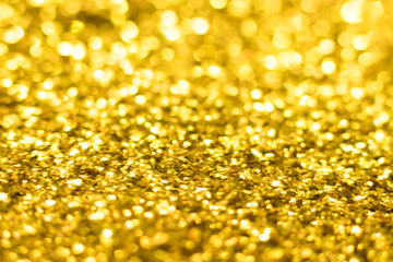 Gold glitter texture. Festive sparkling sequins background. Wpaper for Valentine, New Year or Christmas Holidays.