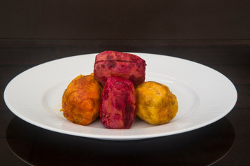 higso prickly pear of two colors on a white plate with dark background