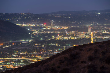 Night cityscape view of Burbank, Verdugo Mountain and the San Fernando Valley in Los Angeles, California.  