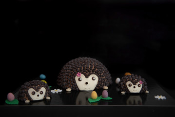 hedgehog family cakes with sweets and reflection