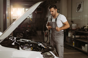 Auto mechanic working with socket wrench in a workshop