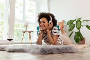 Woman listening to the music and relaxing at home