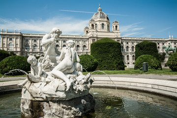 Fototapeta na wymiar Ancient fountain made of white stone in front of Natural History Museum Vienna on the Maria Theresa Square