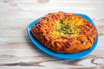 Bread with garlic and cheese on a dark wooden background. Photographed close-up.