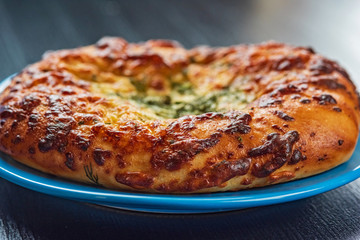 Bread with garlic and cheese on a dark wooden background. Photographed close-up.