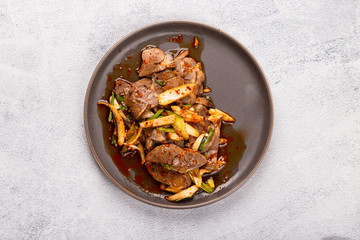 Chinese food: spicy salad with beef on a brown plate