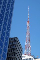 Metal tower or turret telecommunications satellite dishes reception and emission located on the skyscraper