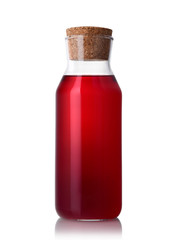 Red glass bottle of juice or compote on a white isolated background. Homemade lemonade carafe on a white background.