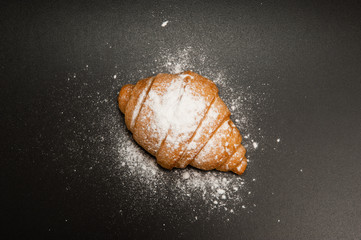 Croissant on a black background. Top view