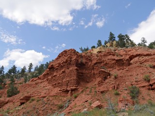 Wide scenic upward shot of red mountain cliffs near the Devils Tower in Wyoming.