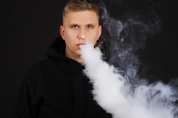Man vape vaping on dark background isolated, Selective focus