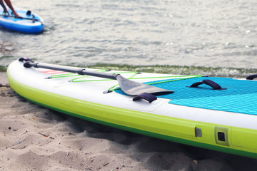 sup board on the beach background. Board for swimming with an oar. Active lifestyle, water sport.