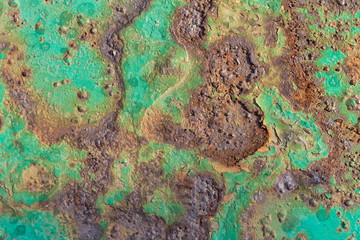 Fragment of old rasty metal surface with peeled turquoise paint. Textured background.