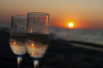 Glass of wine on sunrise, sunset background