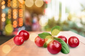 Red cranberries on a wooden table closeup