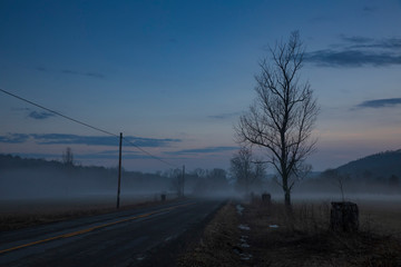 A warm winters fog haunts the landscape near Jenksville, NY at sunset