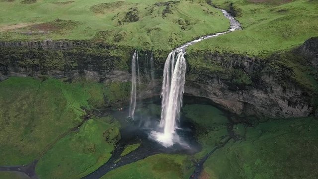 Aerial flight above Seljalandsfoss, famous waterfall in southern Iceland. Beautiful Seljanadsfoss in spirng time.