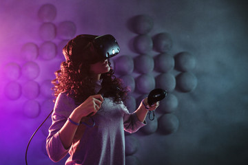 gamer in virtual reality, a girl plays a game or explores the environment in a simulation.