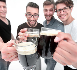 close up.mugs of beer in the hands of a group of men
