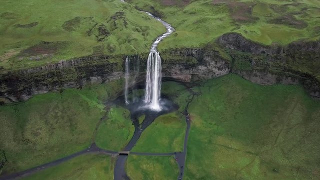 Aerial flight above Seljalandsfoss, famous waterfall in southern Iceland. Beautiful Seljanadsfoss in spirng time.