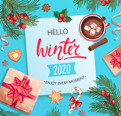 Hello winter 2020 card or banner with hand drawn lettering on blue background with christmas gifts, candies, coffee with cinnamon and marshmallow, cookie, place for text. Top view.Vector Illustration.