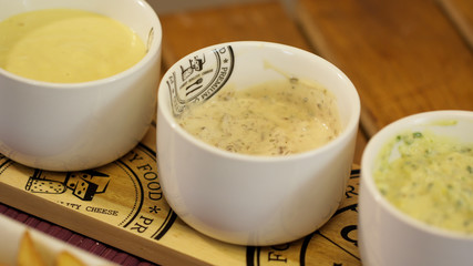Three different flavored mayonnaise bowls to dip snacks