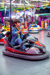 electric car boy at fair with lots of lights