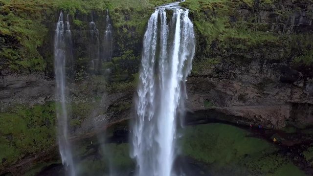 Aerial flight above Seljalandsfoss, famous waterfall in southern Iceland. Beautiful Seljanadsfoss in spirng time. Green Iceland.