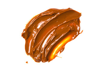 Melted tasty caramel splashes isolated on white background.