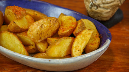 Golden rustic fries served on a colorful tray