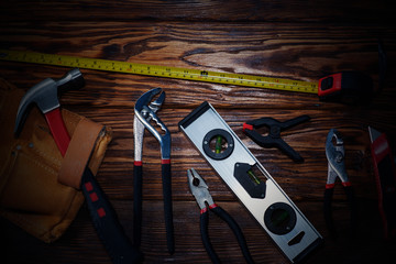 Close up tools on a wooden background.