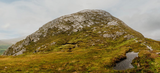 Panorama of Diamond hill in Connemara National Park, county Galway, Ireland, Cloudy day and sky.