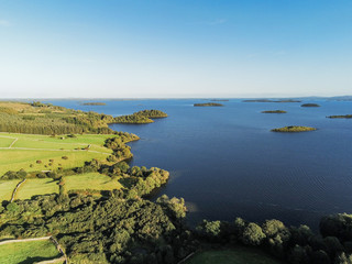 Sunset over Connemara, Lake Corrib, county Galway, warm tones, sun haze. rural landscape.