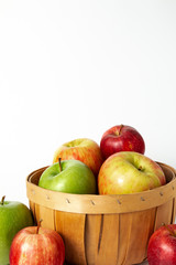 Mixed Apples in Basket on White Background