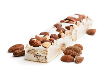 Homemade nougat bar with almonds isolated on white
