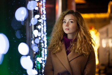 beautiful portrait of a young woman on the street in the new year, Christmas