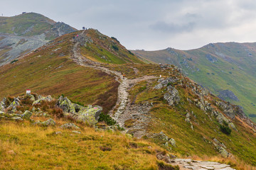 Hiker walking along a trail in the mountains