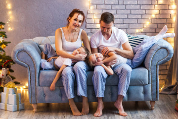 Obraz premium Christmas family with two kids in beautiful living room