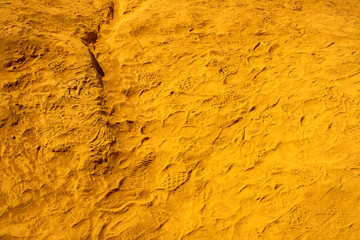 texture of ocher sand full of prints of intense yellow to Roussillon in France